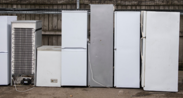 photo of 7 fridges lined up ready to be recycled
