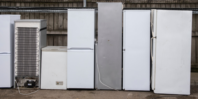 photo of 7 fridges lined up ready to be recycled
