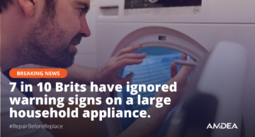 repair engineer looking into a washing machine