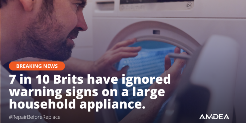 repair engineer looking into a washing machine